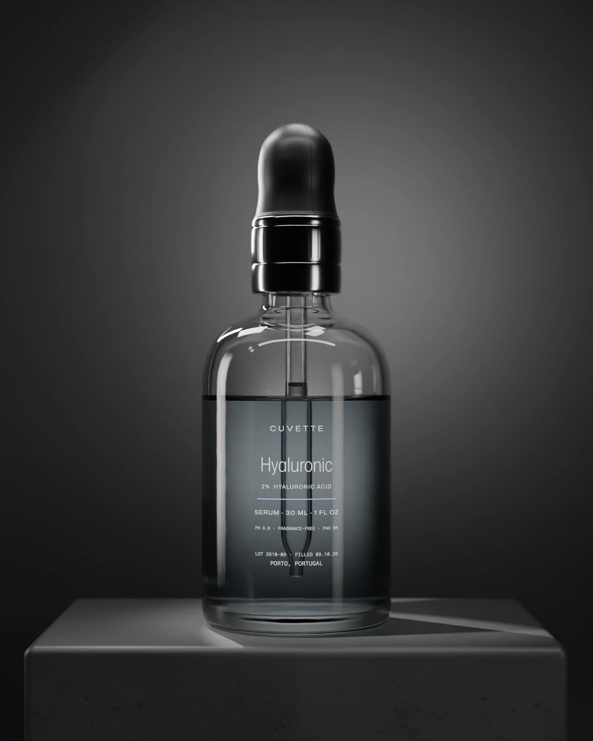 Hyaluronic 2% serum in a glass dropper bottle on a basalt plinth under a single light