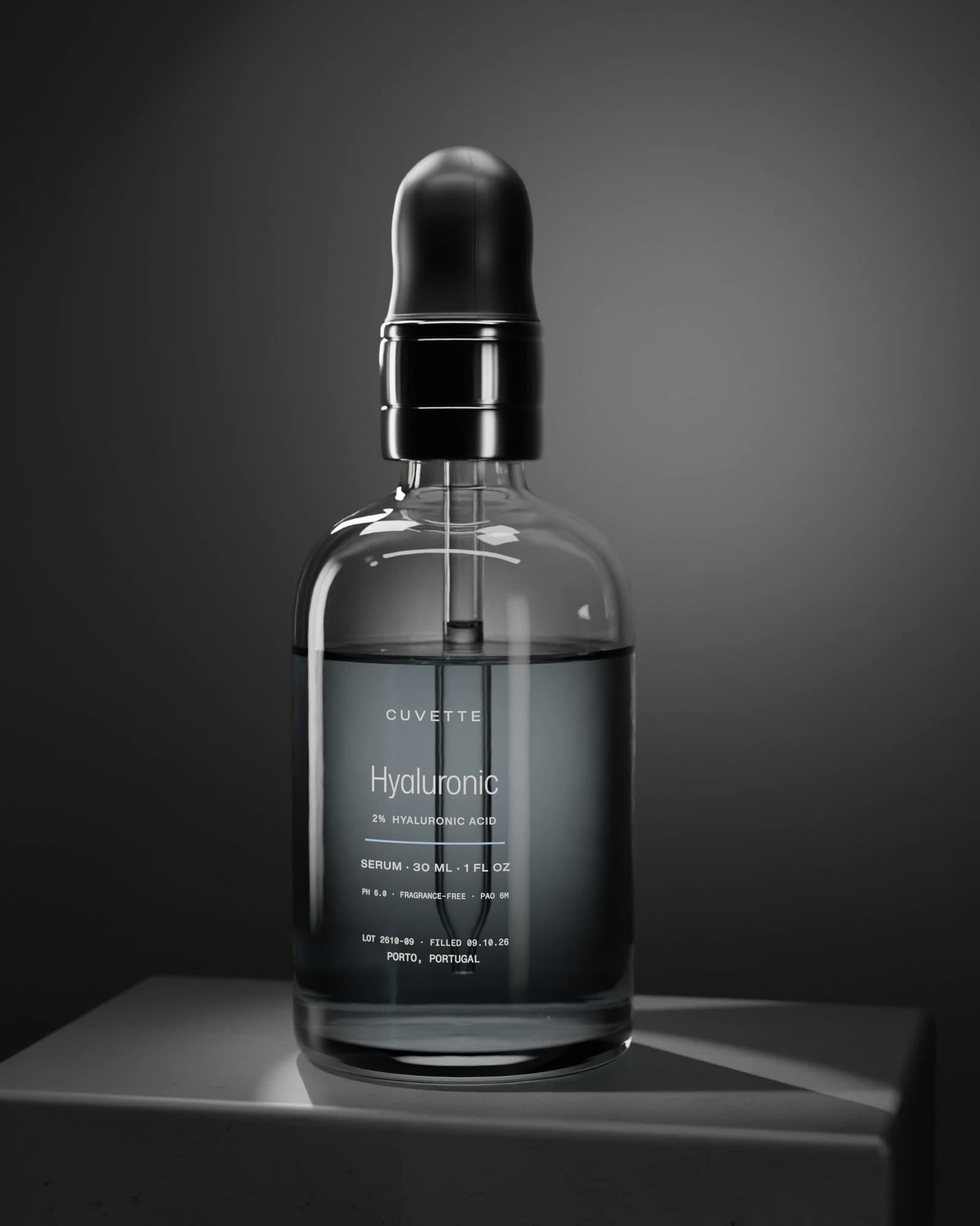 Hyaluronic 2% serum in a glass dropper bottle on a basalt plinth under a single light
