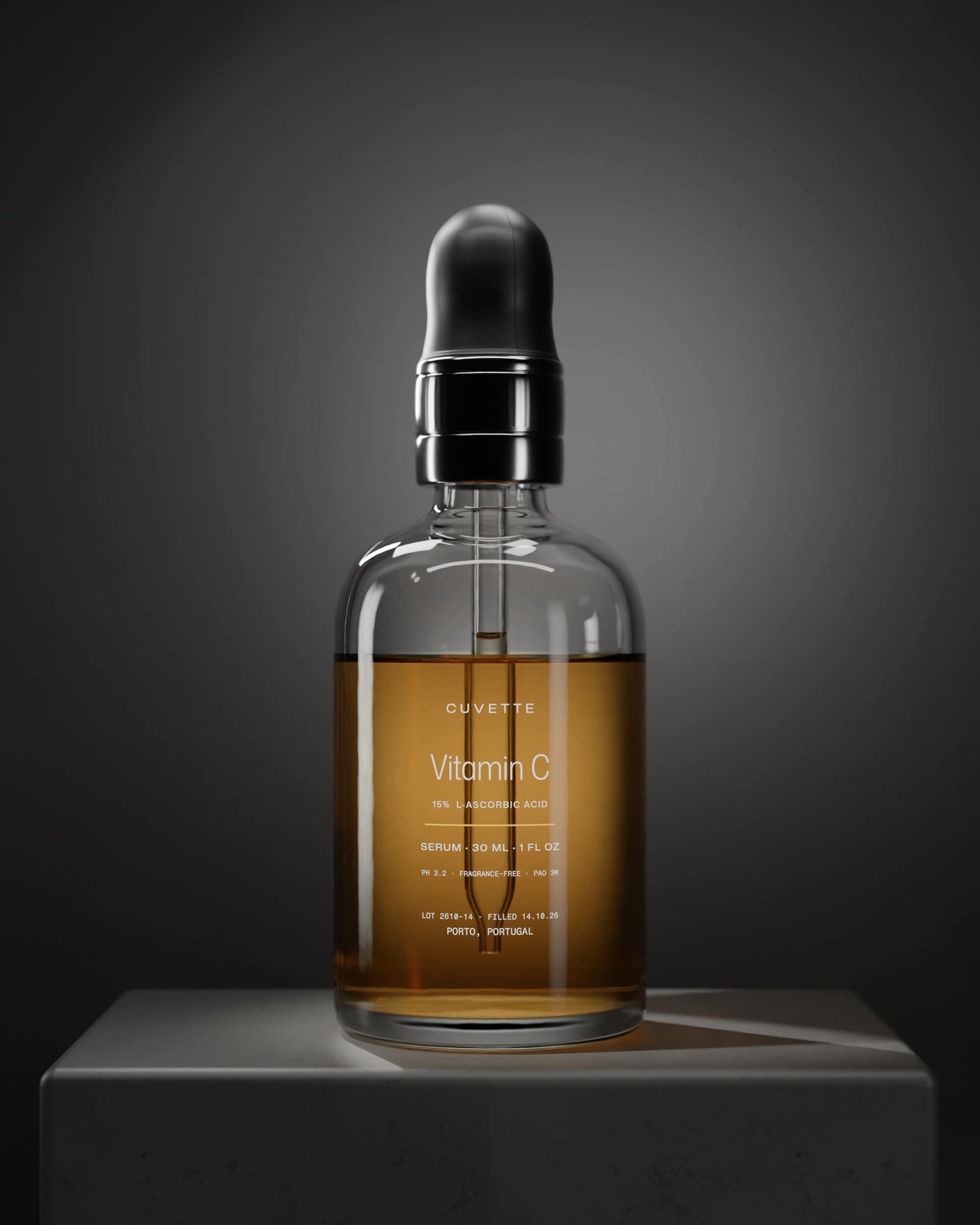 Vitamin C 15% serum in a glass dropper bottle on a basalt plinth under a single light