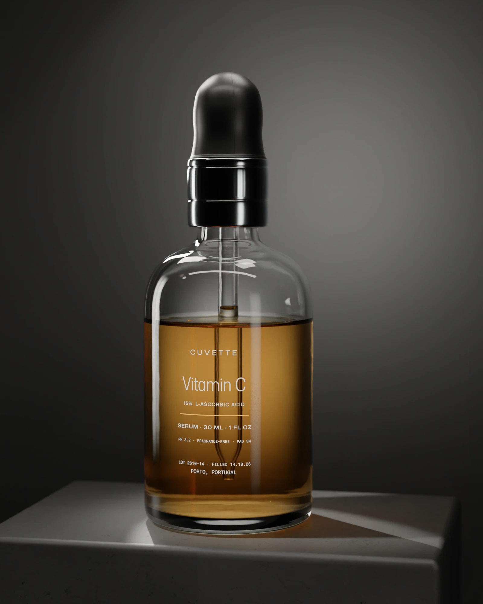 Vitamin C 15% serum in a glass dropper bottle on a basalt plinth under a single light